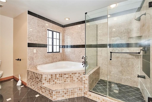 bathroom with baseboards, toilet, tile patterned floors, a garden tub, and a shower stall