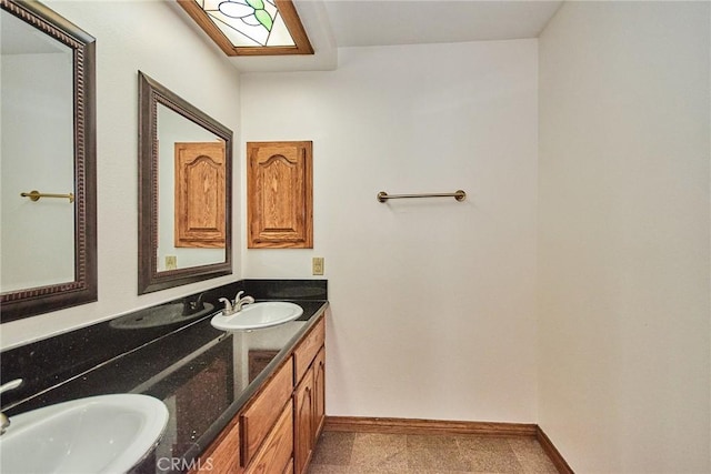 bathroom with a sink and baseboards