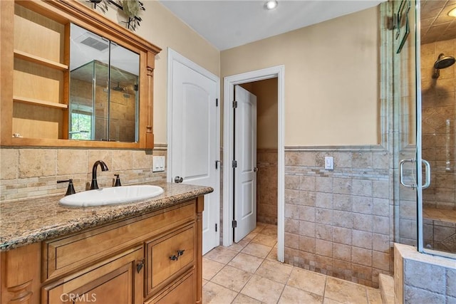 160 Summit Rd, La Verne, CA 91750 - bathroom featuring tile walls, a shower stall, tile patterned floors, vanity, and wainscoting