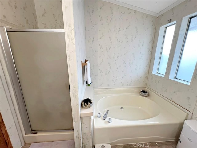 bathroom featuring plenty of natural light and wallpapered walls