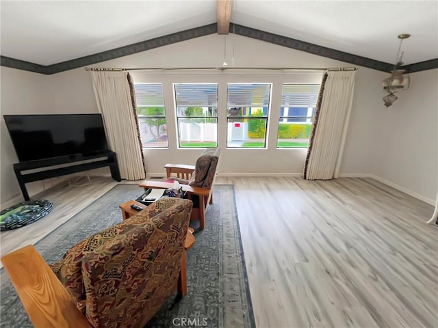 living room featuring vaulted ceiling with beams, baseboards, and wood finished floors