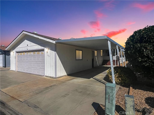 view of front of home featuring concrete driveway and an attached garage