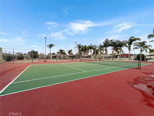 view of sport court featuring fence