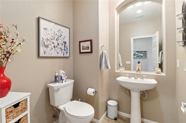 bathroom featuring baseboards, visible vents, and toilet