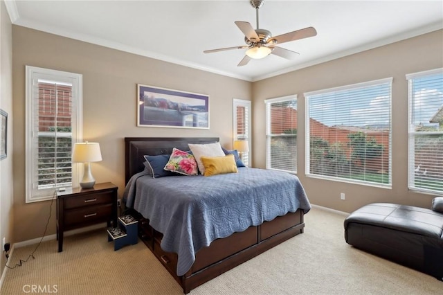 bedroom featuring light carpet, crown molding, baseboards, and ceiling fan