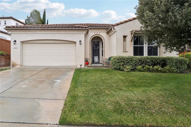 mediterranean / spanish-style house with a garage, stucco siding, concrete driveway, and a front yard