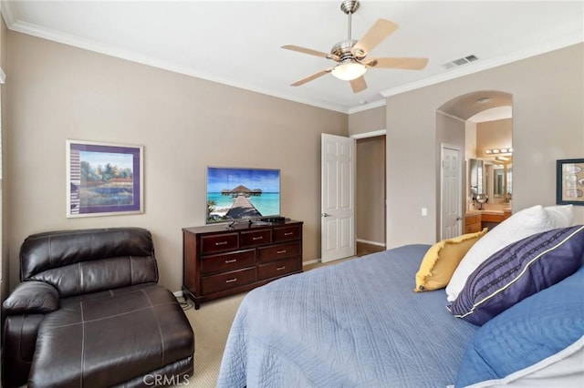 bedroom featuring arched walkways, crown molding, light colored carpet, a ceiling fan, and connected bathroom