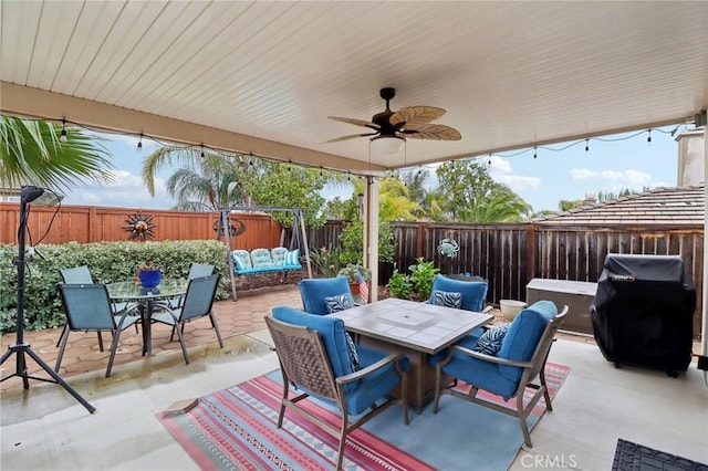 view of patio / terrace featuring outdoor dining area, a grill, a ceiling fan, and a fenced backyard