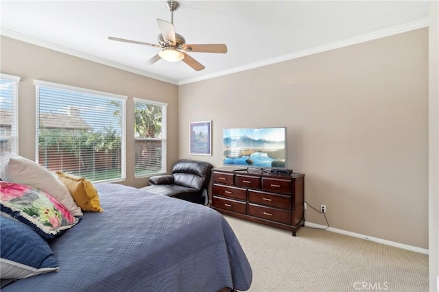 bedroom with ceiling fan, ornamental molding, light colored carpet, and baseboards