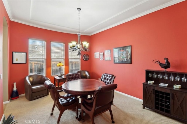 dining room with baseboards, carpet floors, crown molding, and an inviting chandelier