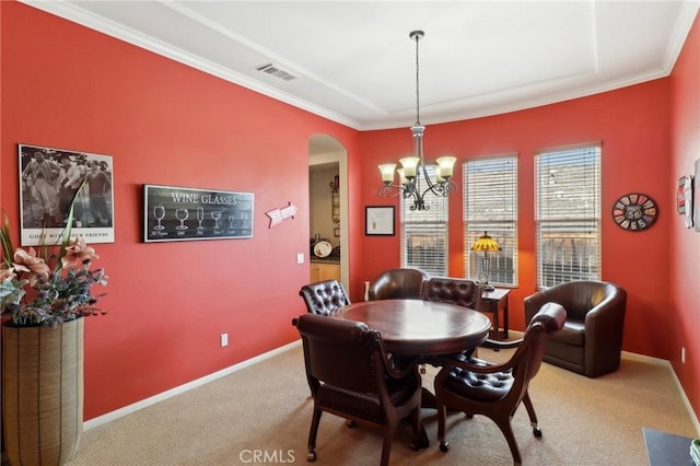 dining room featuring carpet floors, arched walkways, a chandelier, and baseboards