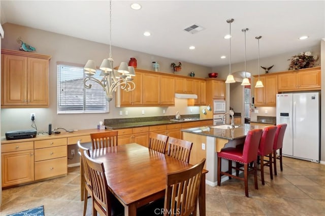 dining space featuring visible vents, a notable chandelier, and recessed lighting