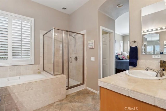 ensuite bathroom with a shower stall, ensuite bathroom, a bath, and vanity