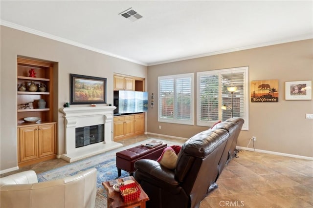 living area featuring a glass covered fireplace, visible vents, crown molding, and baseboards