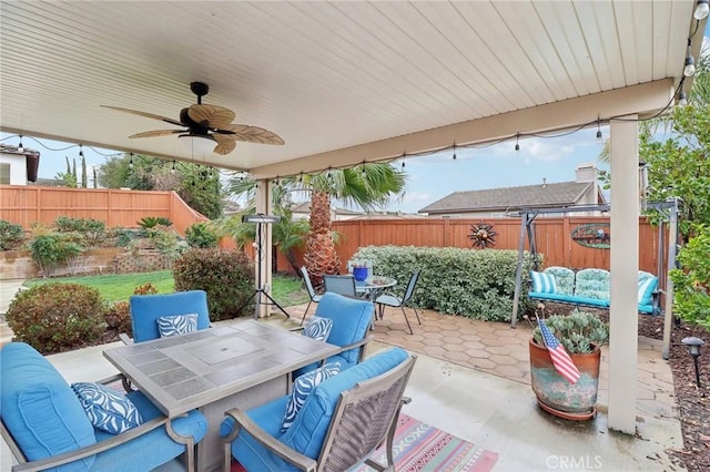 view of patio / terrace with outdoor lounge area, fence, outdoor dining area, and a ceiling fan