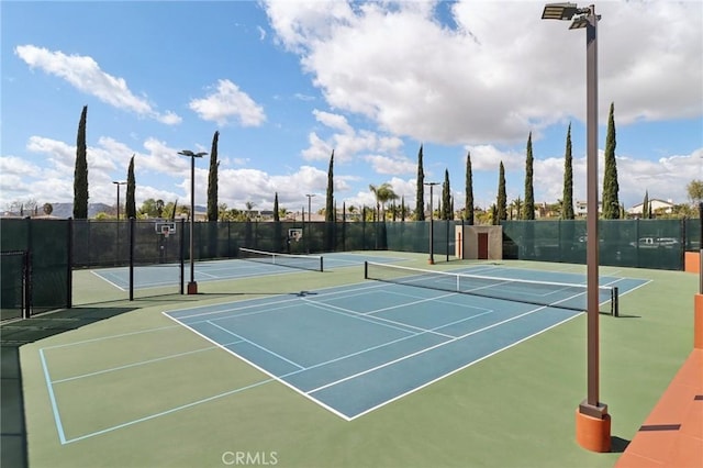 view of tennis court with fence