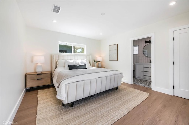 bedroom featuring recessed lighting, visible vents, baseboards, and wood finished floors