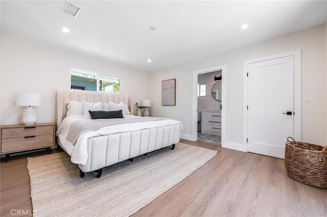 bedroom with light wood finished floors, visible vents, and recessed lighting