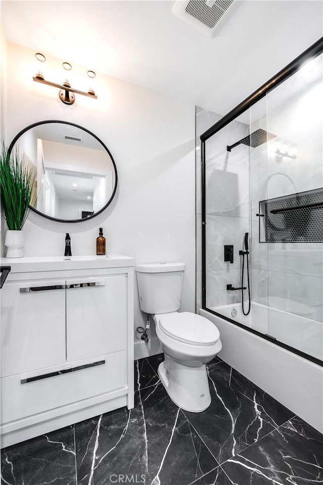 bathroom with visible vents, toilet, marble finish floor, combined bath / shower with glass door, and vanity