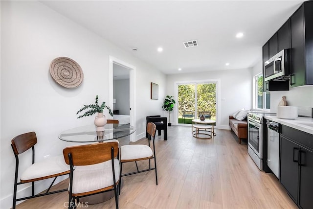 kitchen with visible vents, appliances with stainless steel finishes, light countertops, and dark cabinets