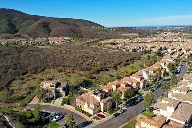 drone / aerial view featuring a residential view and a mountain view