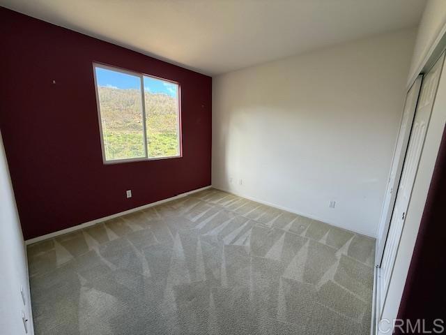 empty room featuring light colored carpet