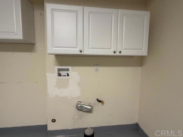 clothes washing area featuring gas dryer hookup, cabinet space, and washer hookup