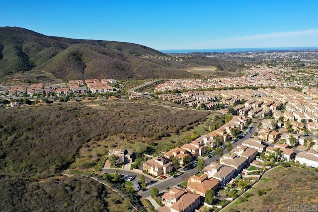 drone / aerial view featuring a residential view and a mountain view