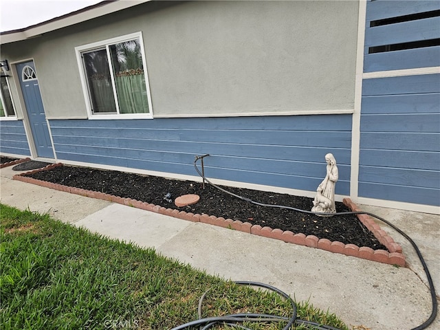 view of side of property featuring stucco siding