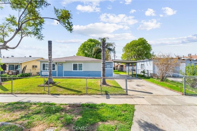 ranch-style house featuring a gate, driveway, a front lawn, a carport, and a fenced front yard