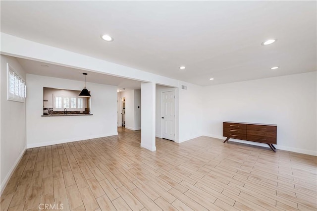 below grade area featuring recessed lighting, light wood-style flooring, and baseboards