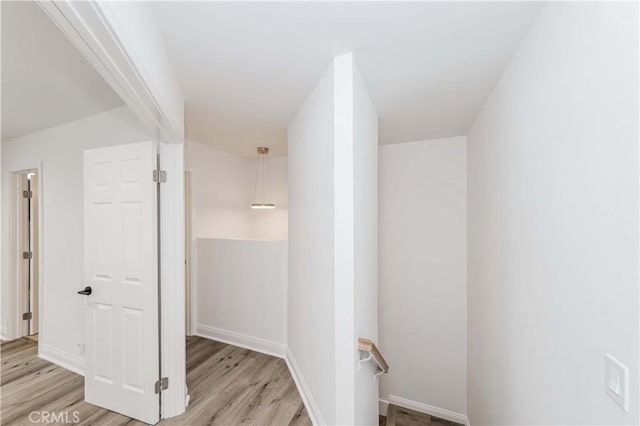 interior space featuring baseboards and wood finished floors