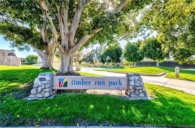 community sign with a lawn and fence