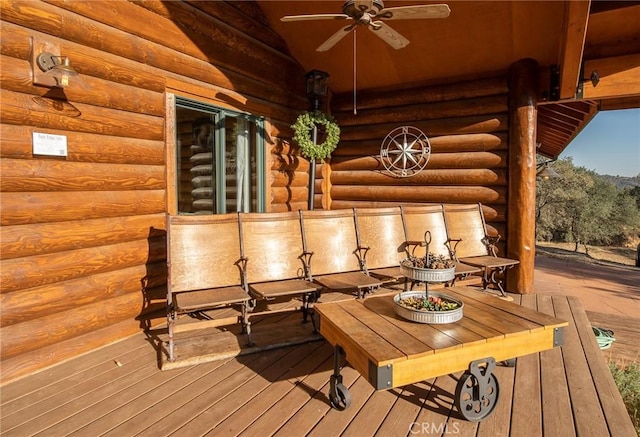 wooden deck featuring ceiling fan