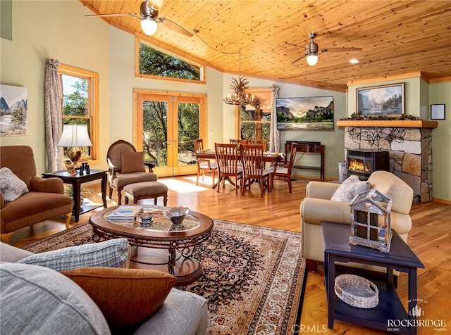 living room featuring french doors, a fireplace, wood ceiling, ceiling fan, and wood finished floors