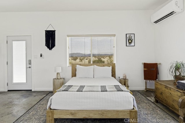 bedroom featuring an AC wall unit, concrete floors, and baseboards