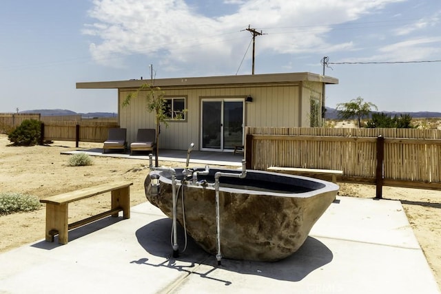 rear view of property with a patio area and fence