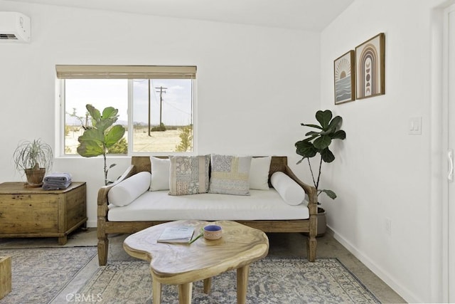 sitting room featuring baseboards and an AC wall unit