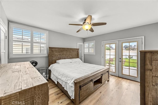 bedroom with a ceiling fan, access to outside, french doors, and light wood finished floors