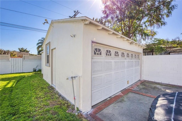 detached garage featuring fence