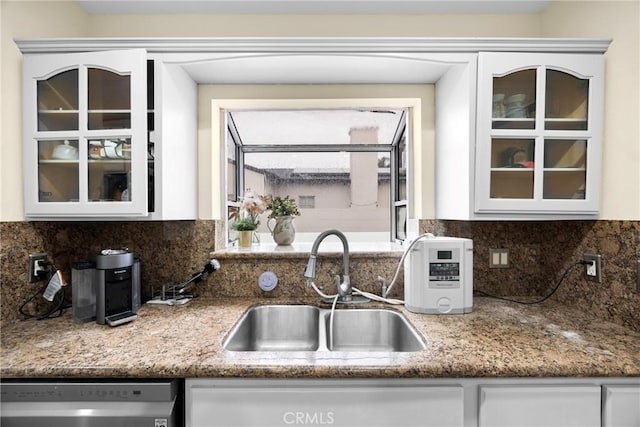 kitchen with a sink, glass insert cabinets, white cabinets, and dishwasher