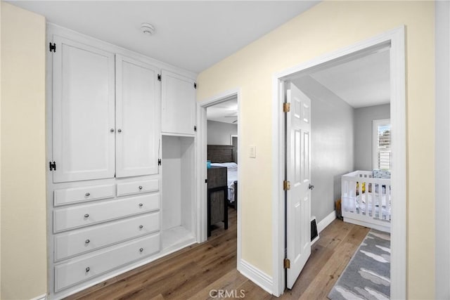 interior space featuring baseboards and wood finished floors