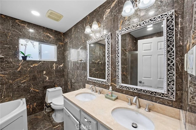 full bath featuring marble finish floor, a sink, tile walls, and toilet