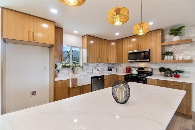 kitchen with stainless steel appliances, backsplash, a sink, and brown cabinets