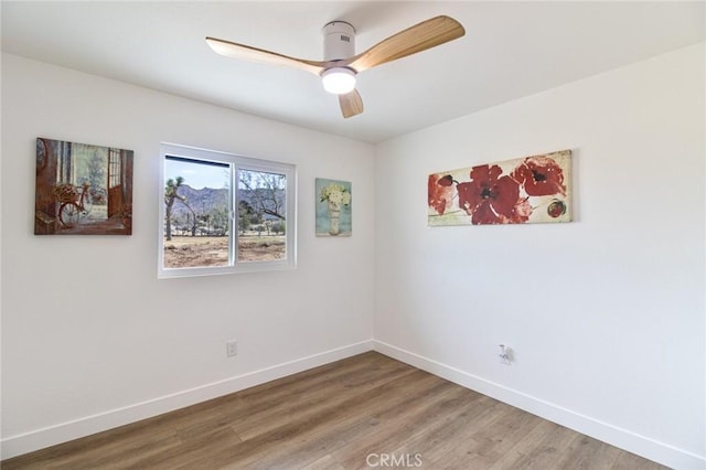 unfurnished room with baseboards, ceiling fan, and light wood-style floors