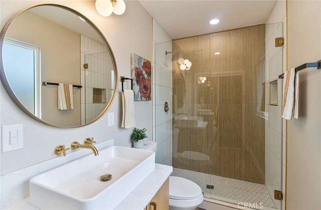 full bath with toilet, a stall shower, recessed lighting, and vanity