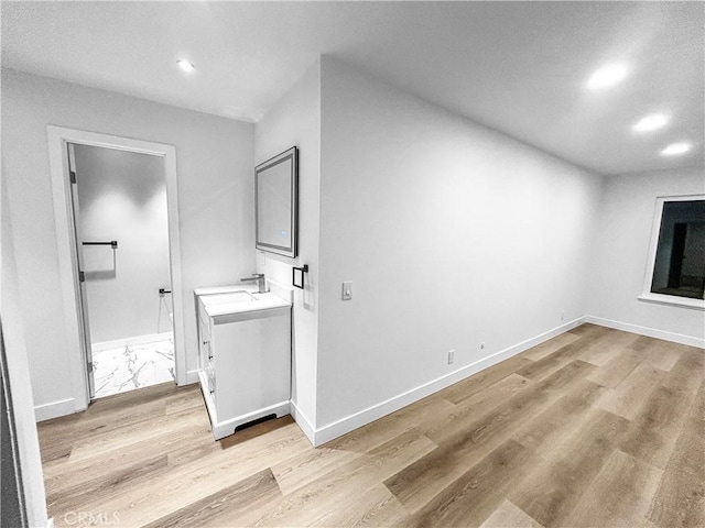 interior space featuring recessed lighting, light wood-type flooring, and baseboards