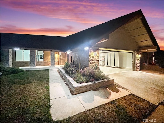 contemporary home with stone siding and a yard