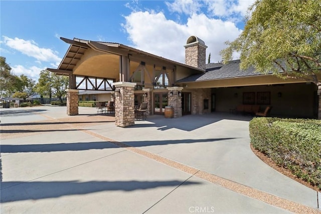 exterior space featuring a patio area and a chimney