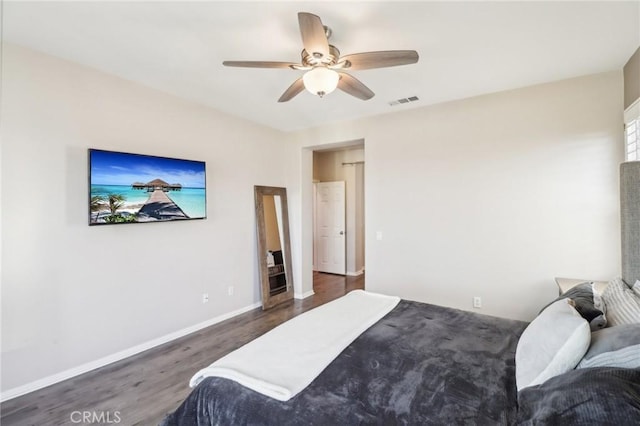 bedroom with visible vents, baseboards, wood finished floors, and a ceiling fan